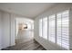 Hallway with wood floors and natural light leads to the kitchen and living area at 12679 W Lowden Rd, Peoria, AZ 85383