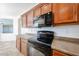 Close-up of kitchen with dark countertops, stainless steel sink, and black microwave oven at 12679 W Lowden Rd, Peoria, AZ 85383