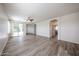 Spacious living room with wood-look floors, ceiling fan, and sliding glass doors to the patio at 12679 W Lowden Rd, Peoria, AZ 85383