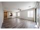 Bright living room with wood floors, ceiling fan, slider door, and multiple windows offering natural light at 12679 W Lowden Rd, Peoria, AZ 85383