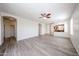 Large living room with modern floors, ceiling fan, and architectural features like arched doorways at 12679 W Lowden Rd, Peoria, AZ 85383