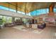 Spacious lobby area with a high ceiling, large windows, comfortable seating, and a fireplace at 12679 W Lowden Rd, Peoria, AZ 85383