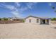 Spacious backyard showcasing a stucco home with neutral landscaping, offering potential for customization at 1343 W Roadrunner Dr, Chandler, AZ 85286