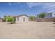 This backyard showcases stucco exterior walls, neutral rock landscaping, and a covered patio at 1343 W Roadrunner Dr, Chandler, AZ 85286