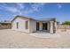 Home backyard featuring stucco, neutral rock landscaping, a covered patio, and black framed sliding glass doors at 1343 W Roadrunner Dr, Chandler, AZ 85286