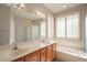 Bathroom features dual sinks, a tub, and shuttered windows for natural light at 1343 W Roadrunner Dr, Chandler, AZ 85286