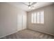 Bedroom with a ceiling fan, plush carpet flooring, closet with sliding doors, and window with shutters at 1343 W Roadrunner Dr, Chandler, AZ 85286