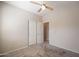 Bedroom with a ceiling fan, plush carpet flooring, and closet with sliding doors at 1343 W Roadrunner Dr, Chandler, AZ 85286