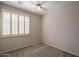 Bedroom featuring shutters on the window, carpet flooring, and a ceiling fan at 1343 W Roadrunner Dr, Chandler, AZ 85286