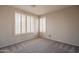 Cozy bedroom with plush carpet, bright windows with shutters, and neutral wall color at 1343 W Roadrunner Dr, Chandler, AZ 85286