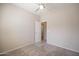 Bedroom with carpet flooring, a ceiling fan, and open doorway with attached bathroom at 1343 W Roadrunner Dr, Chandler, AZ 85286