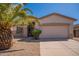 Charming single-story home featuring a two-car garage and desert landscaping with a large palm tree at 1343 W Roadrunner Dr, Chandler, AZ 85286