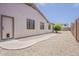 Home exterior displaying stucco walls, neutral landscaping, and a sidewalk and doorway for pet access at 1343 W Roadrunner Dr, Chandler, AZ 85286