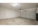 Spacious garage with painted walls, concrete floor, and overhead door with automatic opener at 1343 W Roadrunner Dr, Chandler, AZ 85286