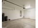 Bright garage with water softener, water heater, and painted white walls at 1343 W Roadrunner Dr, Chandler, AZ 85286