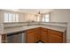 Kitchen bar overlooking the living room, with stainless steel dishwasher and sink at 1343 W Roadrunner Dr, Chandler, AZ 85286