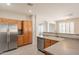 Kitchen with stainless steel appliances, ample cabinetry, and breakfast bar at 1343 W Roadrunner Dr, Chandler, AZ 85286