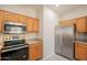 Kitchen with stainless steel appliances and wooden cabinets at 1343 W Roadrunner Dr, Chandler, AZ 85286