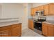 Bright kitchen features stainless steel appliances, ample counter space and tile flooring at 1343 W Roadrunner Dr, Chandler, AZ 85286