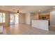 Open concept living room featuring neutral tones, tile flooring, and sliding glass doors to the backyard patio at 1343 W Roadrunner Dr, Chandler, AZ 85286