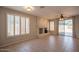 Warm living room with fireplace, tiled floors, shuttered windows, and access to the outdoor patio at 1343 W Roadrunner Dr, Chandler, AZ 85286