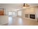 Open floor plan with a fireplace, large windows, tile flooring and view of the kitchen at 1343 W Roadrunner Dr, Chandler, AZ 85286