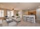 Staged living room with tile flooring, neutral decor, ceiling fan and a view into the kitchen at 1343 W Roadrunner Dr, Chandler, AZ 85286