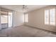 Main bedroom featuring shutters, a sliding glass door to the backyard and a ceiling fan at 1343 W Roadrunner Dr, Chandler, AZ 85286