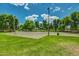 This park showcases a well-maintained basketball court, lush trees, and freshly mowed grass at 1343 W Roadrunner Dr, Chandler, AZ 85286