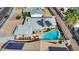 Aerial view of a home featuring a backyard pool with patio and a solar panel roof at 1511 W Mesquite St, Chandler, AZ 85224
