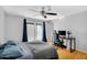 Cozy bedroom with hardwood floors, ceiling fan, and workspace at 1511 W Mesquite St, Chandler, AZ 85224