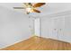 Bright bedroom features a ceiling fan, light walls, wood-look flooring, and a spacious closet at 1511 W Mesquite St, Chandler, AZ 85224