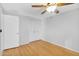 Bright bedroom features wood-look flooring, a ceiling fan, and a closet at 1511 W Mesquite St, Chandler, AZ 85224