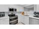 Updated kitchen with stainless steel appliances, white cabinets, and modern countertop at 1511 W Mesquite St, Chandler, AZ 85224