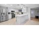 Modern white kitchen featuring stainless steel appliances, sleek countertops, and bright lighting at 1511 W Mesquite St, Chandler, AZ 85224