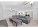 Open-concept living area with a comfortable sectional sofa, tile floors, and modern ceiling fans at 1511 W Mesquite St, Chandler, AZ 85224