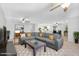 Spacious living room featuring a large sectional sofa, ceiling fans, and an open floor plan leading to the kitchen at 1511 W Mesquite St, Chandler, AZ 85224
