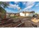 Large backyard featuring arched architectural elements, mature palm trees, and garden beds; a tranquil outdoor space at 1602 N 73Rd Ave, Phoenix, AZ 85035