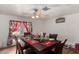 Cozy dining area featuring a ceiling fan and a table setting for six near French doors at 1602 N 73Rd Ave, Phoenix, AZ 85035