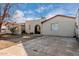 The inviting front exterior shows a single story home with a stone pathway and an arched entryway at 1602 N 73Rd Ave, Phoenix, AZ 85035
