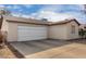 Spacious two-car garage featuring a smooth driveway and an adjacent single story home at 1602 N 73Rd Ave, Phoenix, AZ 85035