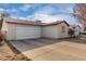 Spacious two-car garage featuring a smooth driveway and an adjacent single story home at 1602 N 73Rd Ave, Phoenix, AZ 85035