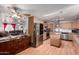 Open kitchen and living room layout with stainless steel appliances, pot rack and ample cabinet space at 1602 N 73Rd Ave, Phoenix, AZ 85035