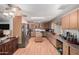 Spacious kitchen with wood-style flooring, center island, stainless steel appliances, and ample cabinet storage at 1602 N 73Rd Ave, Phoenix, AZ 85035