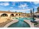 Sparkling pool with water feature, framed by an arched patio and lush greenery, creating a serene backyard retreat at 1602 N 73Rd Ave, Phoenix, AZ 85035