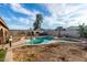 Backyard pool with a decorative fountain feature, complemented by lush landscaping and a charming windmill accent at 1602 N 73Rd Ave, Phoenix, AZ 85035