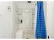 Shower-tub combo featuring blue patterned shower curtains, a bench seat, and a showerhead at 1602 N 73Rd Ave, Phoenix, AZ 85035