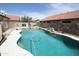 The backyard features a large pool and spa with rock features, fence, and patio at 16233 N 32Nd Ave, Phoenix, AZ 85053