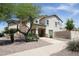 Charming two-story home with a stone chimney, desert landscaping, and a welcoming front porch at 16233 N 32Nd Ave, Phoenix, AZ 85053