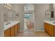 Bathroom featuring double sinks with tile floors that leads to a living room at 1633 E Jasmine St, Casa Grande, AZ 85122